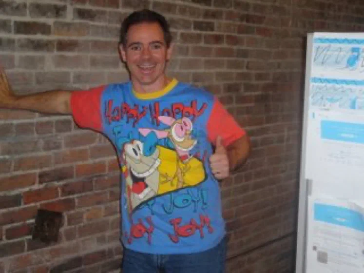 A man in a colorful Happy Happy Joy Joy shirt