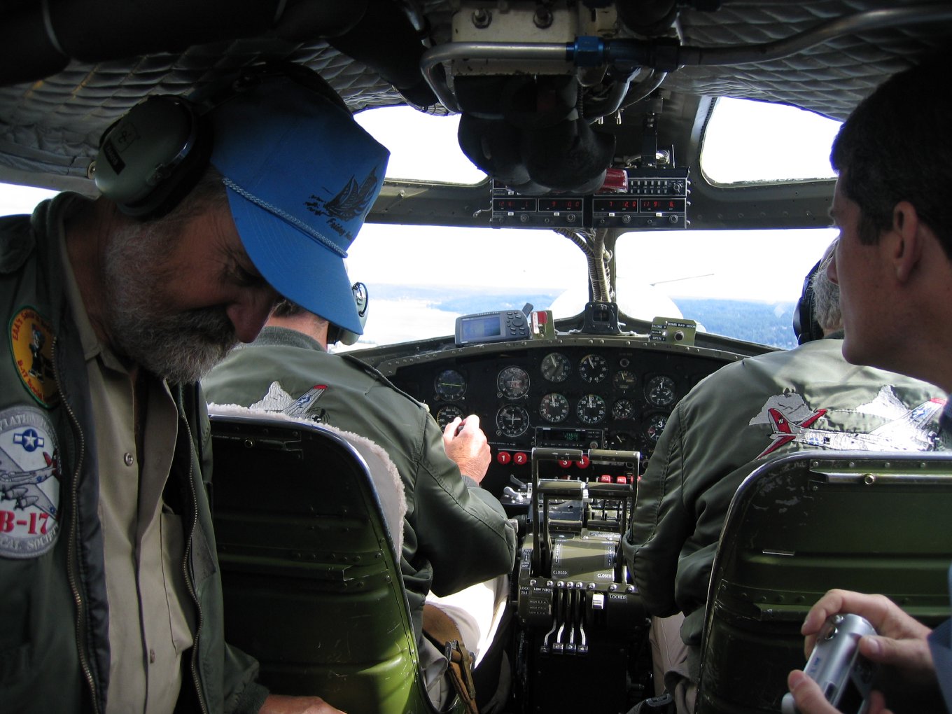 The two pilots at the controls, seen from behind, with the instrument panel ahead