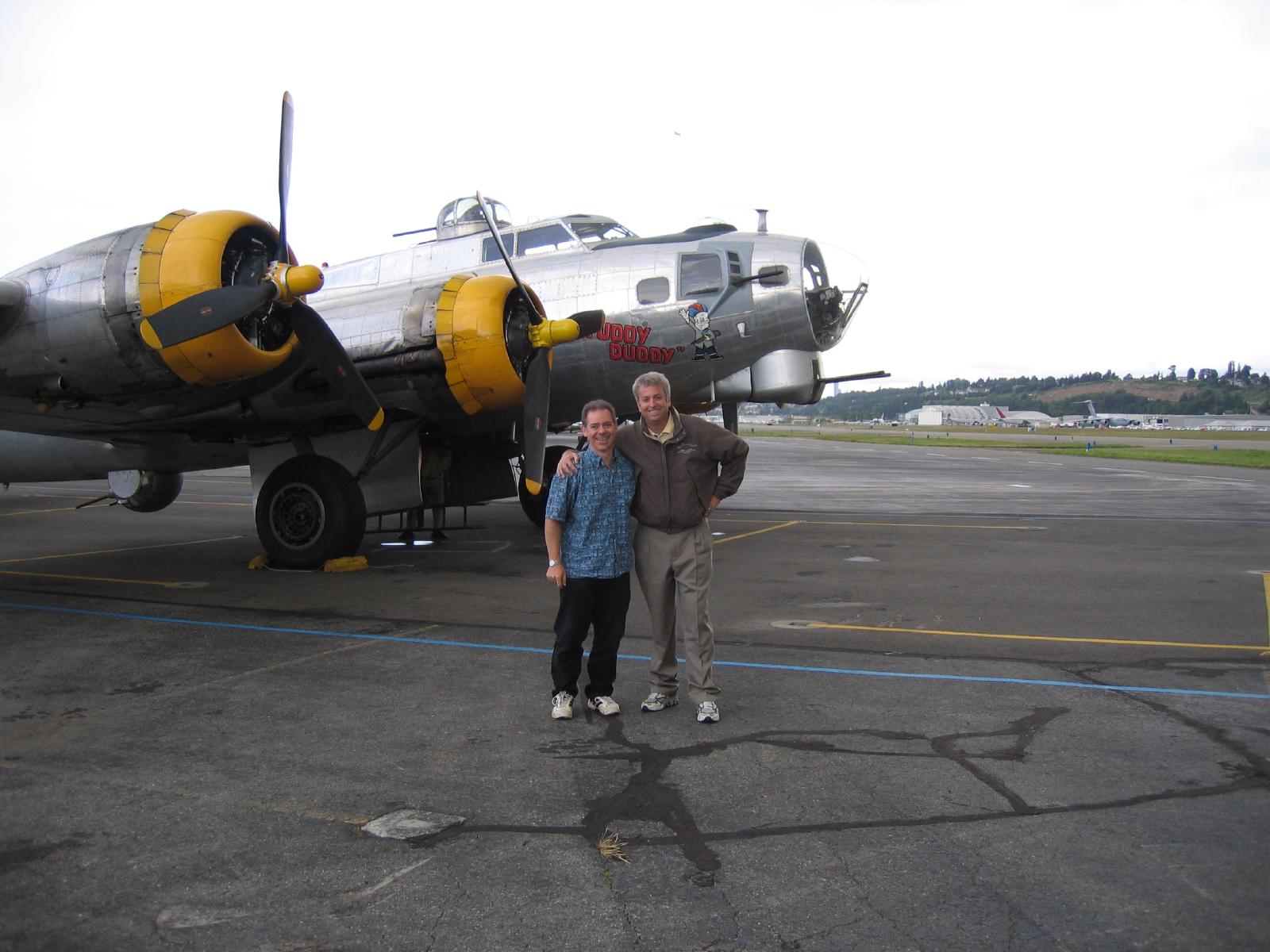 Brian and Mike standing in front of the silver B-17G Fuddy Duddy