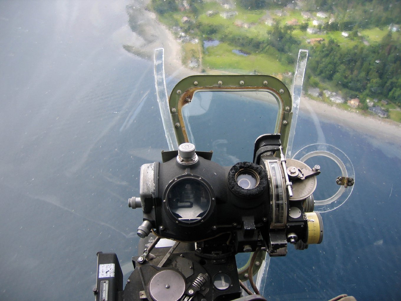 The Norden bombsight in the nose, with the shoreline far below