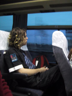 Chris in a bus seat, looking out the window