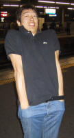 Daigo standing on a train platform at night