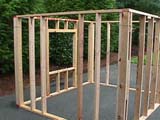 The wall frames standing assembled in the driveway