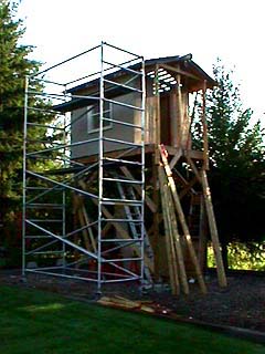 Rolling scaffolding set up beside the sided platform house