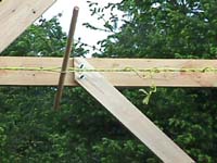 A rope twisted tight with a dowel around the platform beams